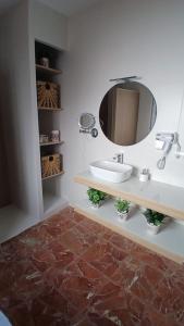 a bathroom with a sink and a mirror at El Molinero in Monesterio +4 photos