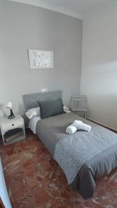 a bedroom with a bed and a nightstand and a bed sidx sidx sidx sidx at El Molinero in Monesterio