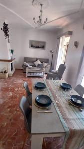 a living room with a table with plates on it at El Molinero in Monesterio