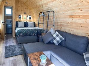 a living room with a couch and a bed at Birch - Uk51862 in Reighton