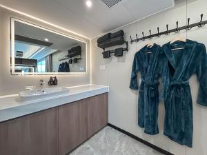 a bathroom with a sink and a robe hanging on a wall at Vessel 1 - Ukc9441 in Glasgow