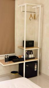 a room with a bed and a book shelf at NestSort Hotel in Mysore