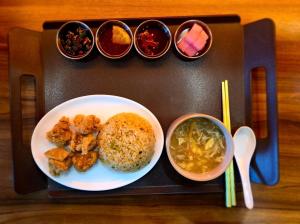 a tray with a plate of food and bowls of food at The Ace Hotel in Seoul