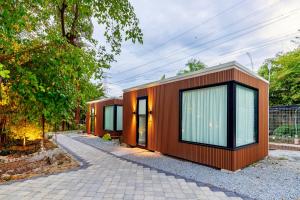 a small house with orange walls and windows at Nadi Glamping Suites, Auto-City in Perai