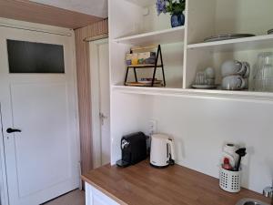 a kitchen with a counter with a coffeemaker on it at Onder de regenboog in Egmond aan den Hoef