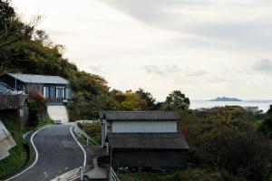 a house on a hill next to a road at Gunkanjima 307 in Nagasaki +40 photos