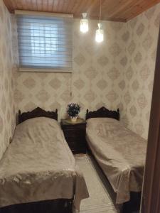 a bedroom with two beds and a window at Beach House Buzovna in Baku