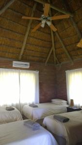 A bed or beds in a room at Umziki Chalets