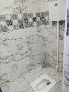 a bathroom with a white toilet in the floor at Beach House Buzovna in Baku +14 photos