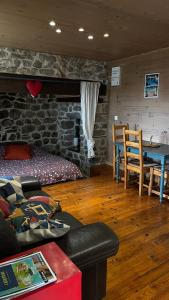 a living room with a couch and a table at Votre cocon en Ardèche Verte in Saint-Prix