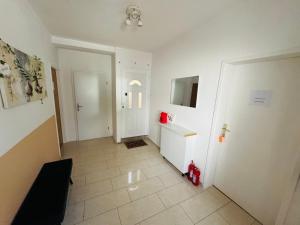 a hallway with a white door and a tile floor at Apartmani Luciano in Novalja