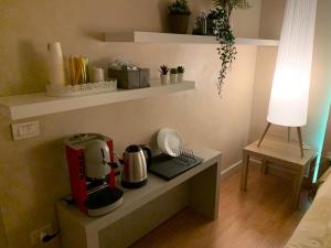 a kitchen with a coffee maker on a shelf at B&B La Littorina - Parcheggio Privato in Foligno