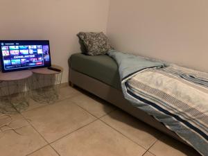 ein Schlafzimmer mit einem Bett und einem Computermonitor in der Unterkunft Haus Tun in Waldbröl + 23 Fotos