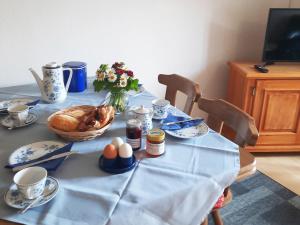 a table with a blue table cloth on it with eggs and a turkey at Ferienwohnung Mutzenbauer in Bad Endorf