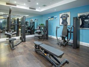 a gym with several treadmills and machines in a room at Novotel Edinburgh Park in Edinburgh