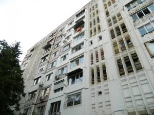 a tall white building with many windows at Modern Apartment in Chişinău