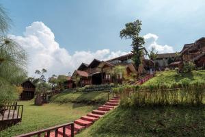 a group of houses on a hill with stairs at RB Cottage Resort By ARBA in Palayangan