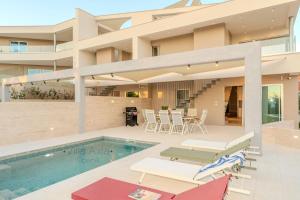 a villa with a swimming pool and a house at Villa Axia Šibenik in Šibenik