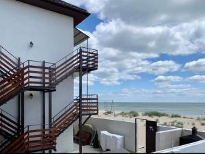 a building with stairs leading to the beach at Mirage Hotel in Zatoka