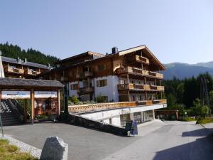 a view of a building with a parking lot at Panorama Chalets am Pass Thurn in Mittersill
