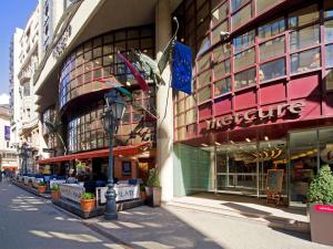 an empty street in front of a large building at Mercure Budapest City Center in Budapest