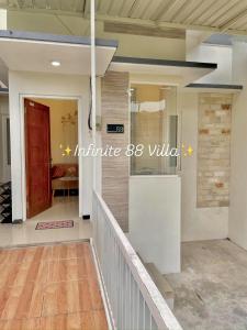 a hallway of a house with a staircase and a door at infinite 88 villa in Batu