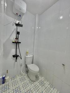 a bathroom with a white toilet in a room at infinite 88 villa in Batu +11 photos