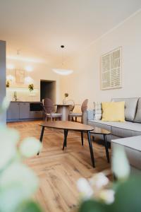a living room with a couch and a table at Apartamenty Rynek 12 in Tarnów