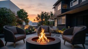 a fire pit in the middle of a patio with chairs at Ruhe K in Kusatsu