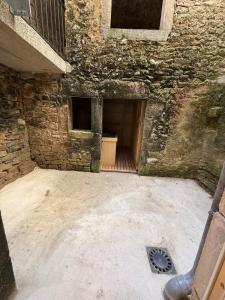 an empty room with a door in a stone building at Gîte Région des Lacs - SPA et Sauna Privatif in Orgelet