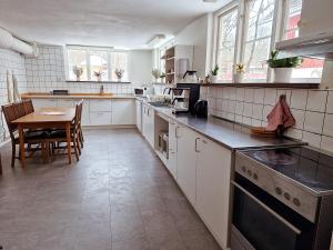 a large kitchen with a table and a counter top at EFS-gården in Åsljunga