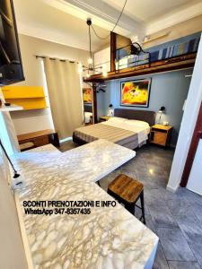 a hotel room with two beds and a tv at Scilla Guest House in Scilla
