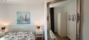 a bedroom with a bed and a large mirror at Drescher Apartments in Murter