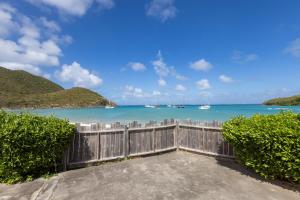 a view of the beach from a fence at Sun et Sea Dreams in Anse Marcel 
