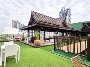 a gazebo with chairs and tables on a roof at True Siam Rangnam Hotel in Bangkok +73 photos