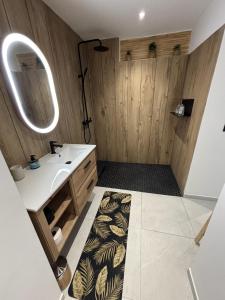 a bathroom with a sink and a mirror at Sun et Sea Dreams in Anse Marcel  +14 photos
