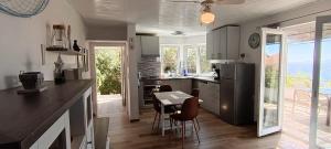 a kitchen with a table and chairs and a dining room at Drescher Apartments in Murter