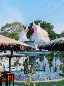 a statue of flamingos on top of a building at Infenta's Villa Hotel & restaurant in Pandattarippu