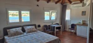 a bedroom with a bed and a table and chairs at Apartments Valentina Tisno in Tisno