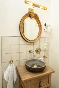 a bathroom with a stone sink and a mirror at Mosel Panorama Studio auf Burg Coraidelstein in Klotten +7 photos
