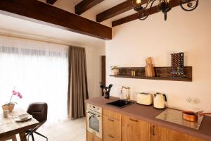 a kitchen with a counter top and a table and a window at Mosel Panorama Studio auf Burg Coraidelstein in Klotten