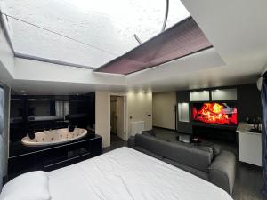 a bedroom with a bed and a couch and a fireplace at Kent Suites Hotels Ataşehir in Istanbul