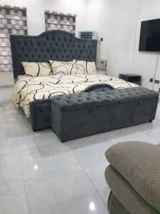 a bedroom with a large bed in a room at Sbk3apartments in Ologode
