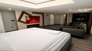 a bedroom with a bed and a living room with a fireplace at Kent Suites Hotels Ataşehir in Istanbul