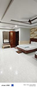 a bedroom with a large bed in a room at Shree radhe palace in Datia