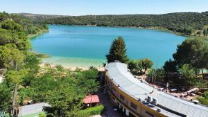 a view of a lake with a building next to it at Hotel Entrelagos in Ruidera