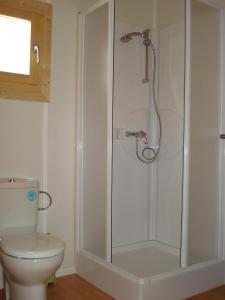 a shower stall in a bathroom with a toilet at Camping Sitges in Sitges