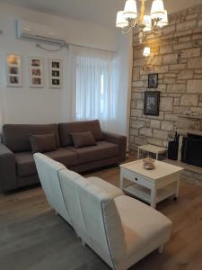 a living room with a couch and a table at Vogklis House in Qeparo