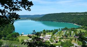 a view of a lake with houses and trees at Chalet Le CERF in Marigny
