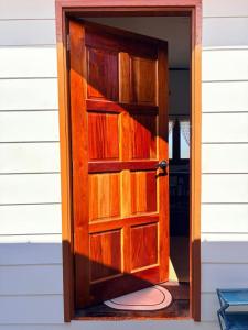 a wooden door is open on a house at Ciao Bella in Dungun